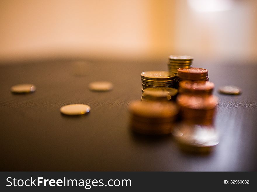 Close up of stacks of coins on wooden desktop. Close up of stacks of coins on wooden desktop.