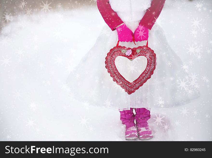 Person in Pink White Dress Holding Red Heart Purse