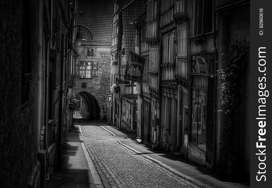 Exterior of medieval buildings on cobblestone streets at night in black and white. Exterior of medieval buildings on cobblestone streets at night in black and white.