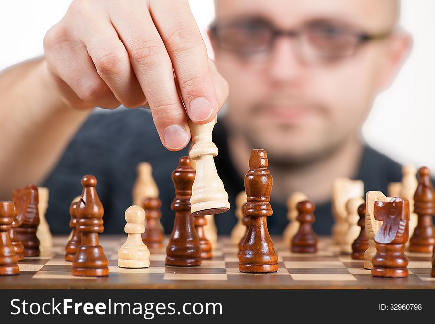 Man Holding Chess Piece