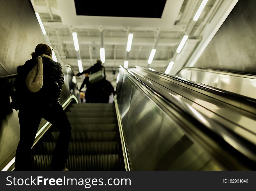 People walking up on an escalator.