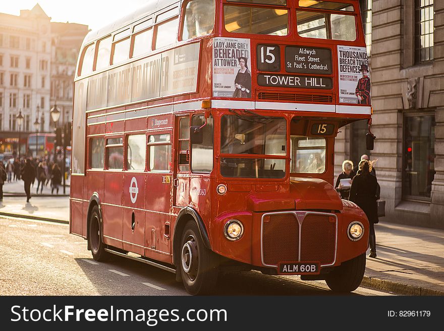 Number 15 London red bus traveling towards Tower Hill via Aldwych and St. Paul's cathedral stopped to pick up passengers in late afternoon golden sunshine. Number 15 London red bus traveling towards Tower Hill via Aldwych and St. Paul's cathedral stopped to pick up passengers in late afternoon golden sunshine.