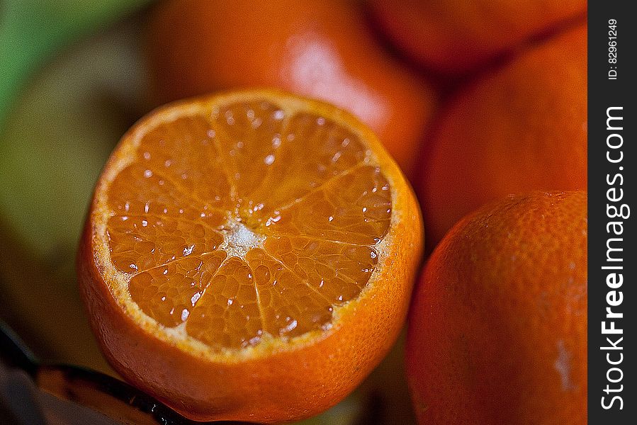 Fresh sliced orange close up with pile of fruits. Fresh sliced orange close up with pile of fruits.