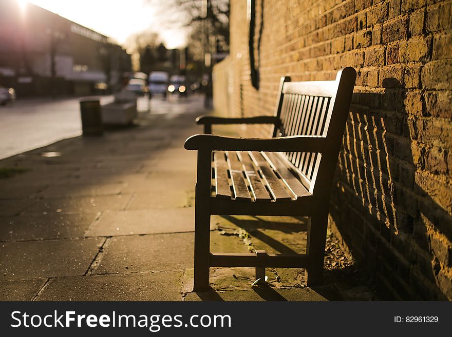 Brown Wooden Bench On The Side Of The Road