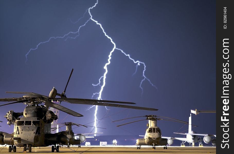 Lightning Near Grey Helicopter during Daytime