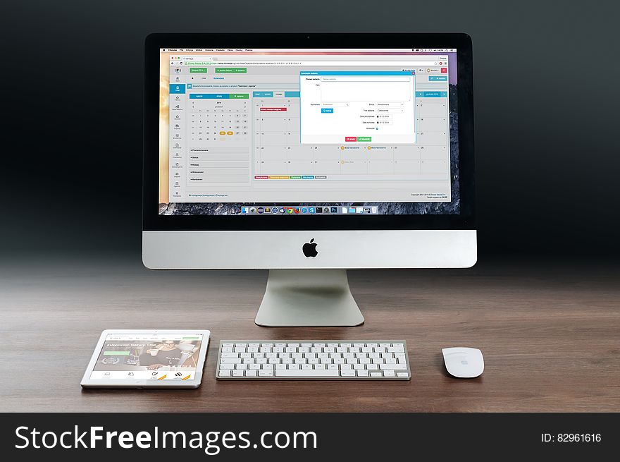 Apple Computer And Tablet On Desktop