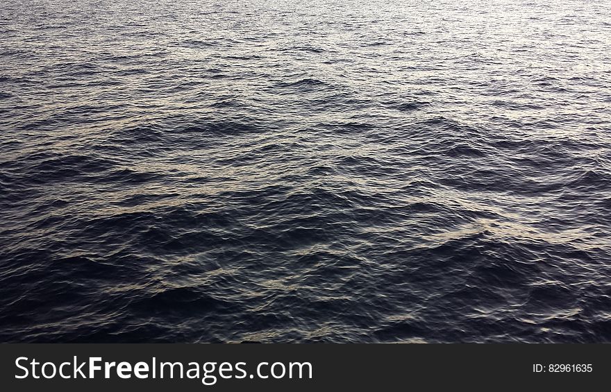 Waves in surface of water with sunshine. Waves in surface of water with sunshine.