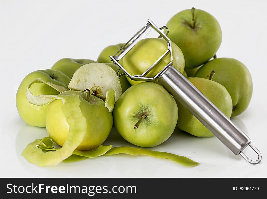 Green Unripe Apple With Silver Peeler