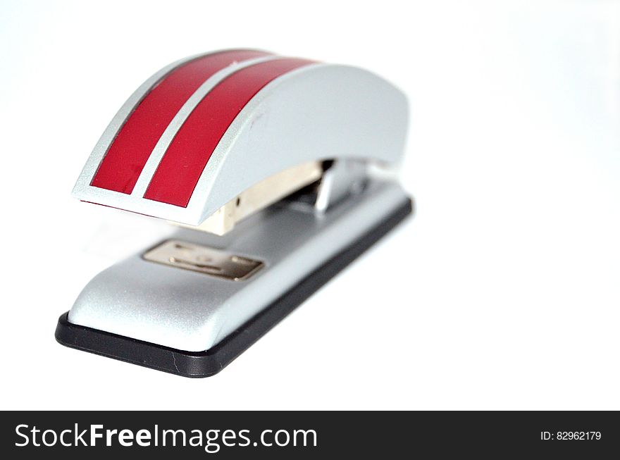 A red striped stapler on white background.
