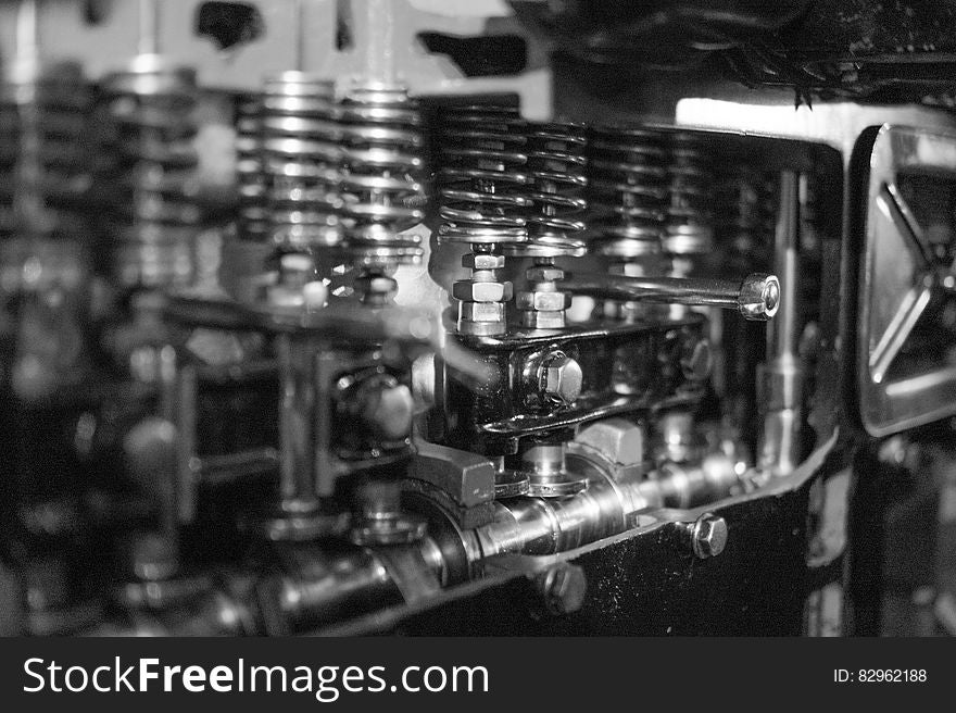 A close up of a engine cylinder head in black and white.
