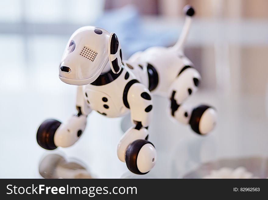 White and Black Dog Robot on Clear Glass Table