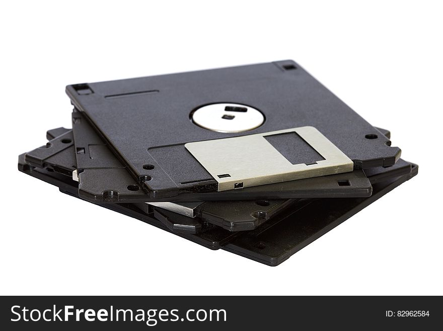 Pile of black floppy discs, now retro, for data storage on computers, white background. Pile of black floppy discs, now retro, for data storage on computers, white background.