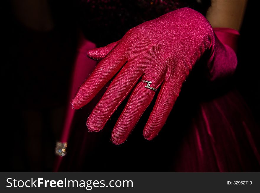 Person in Red Glove With Silver Ring