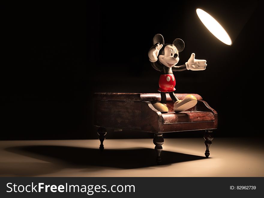 3d Mickey Mouse character dancing on piano under spotlight. 3d Mickey Mouse character dancing on piano under spotlight.