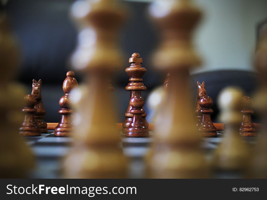 Game of chess in progress viewed at board level looking between two pieces to king.