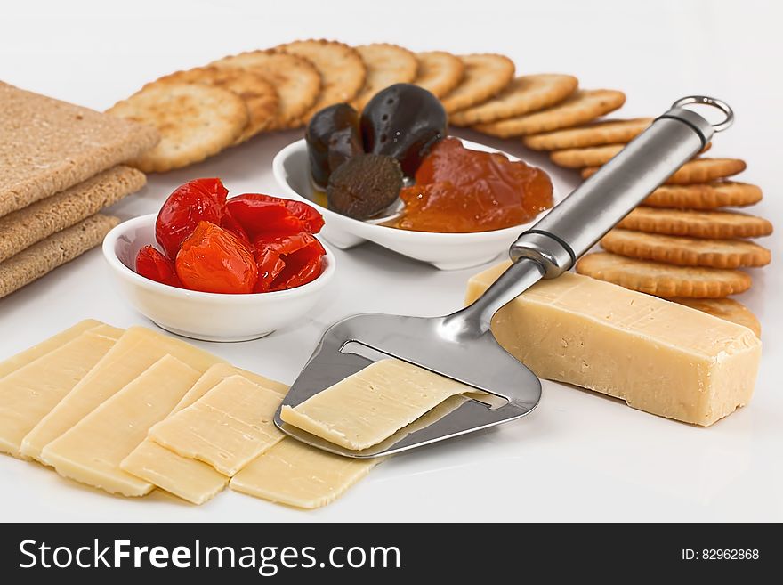 Hors d'oeuvre or savoury dish served as an appetizer and composed of cheese, dates, biscuits, black pudding and jelly, white background. Hors d'oeuvre or savoury dish served as an appetizer and composed of cheese, dates, biscuits, black pudding and jelly, white background.
