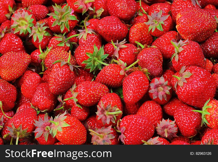 A pile of ripe red strawberries.