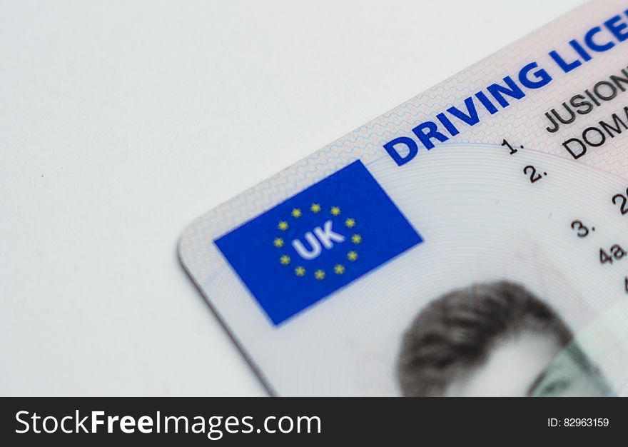Close up of logo and front of UK drivers license.