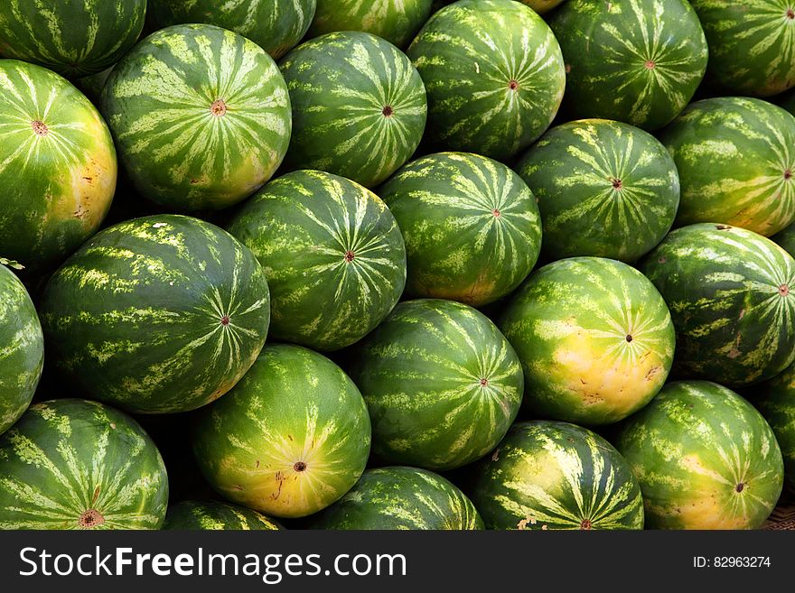 Stack of green ripe watermelons on display. Stack of green ripe watermelons on display.