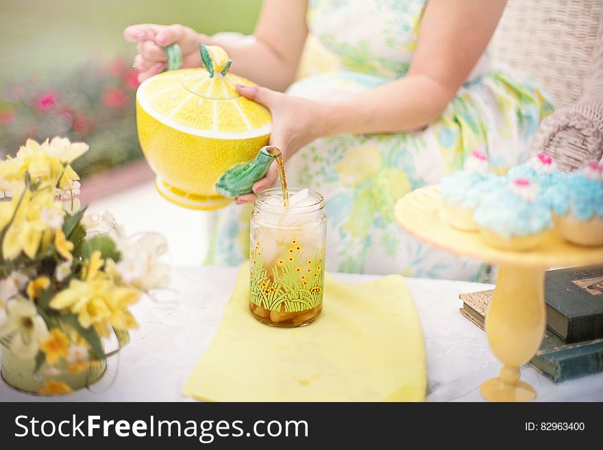 Person Holding Yellow and Green Lime Shape Ceramic Tea Pot