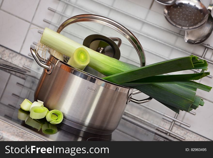White and Green Vegetable on Top of Stainless Steel Cooking Pot