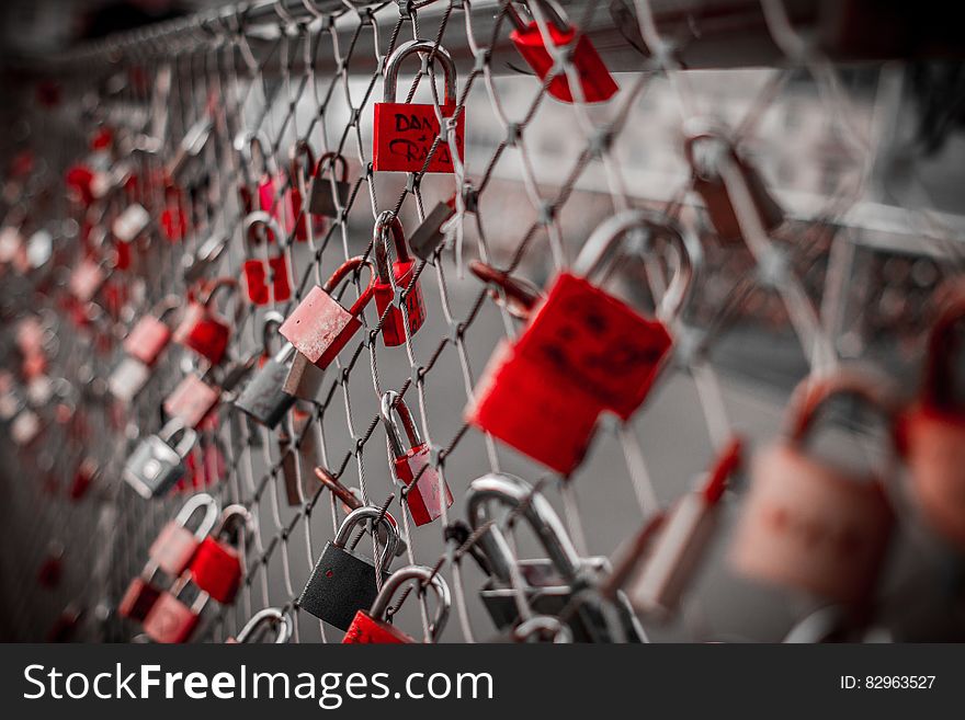 Red Padlock on Cyclone Fence