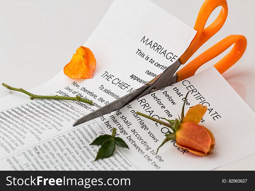 Printer Paper Cut With Orange Scissor