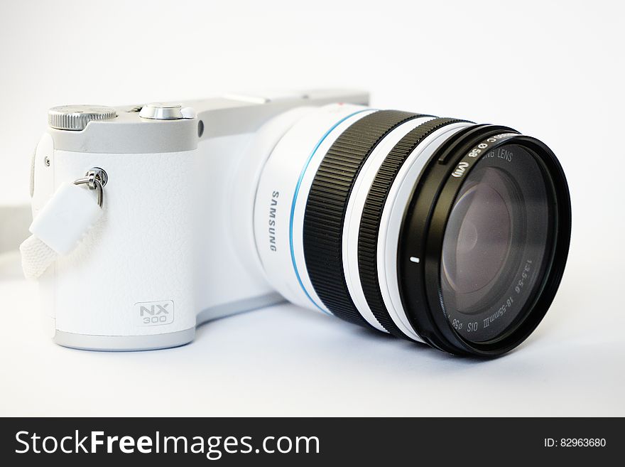 Closeup of Samsung NX300 digital camera on white background.