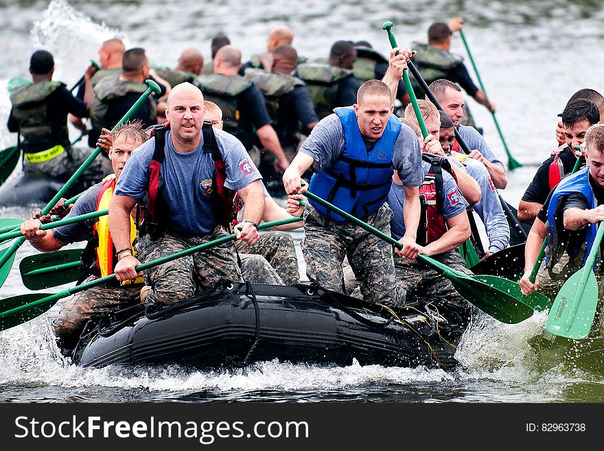 Men Paddling in Inflatable Raft Boat during Daytime