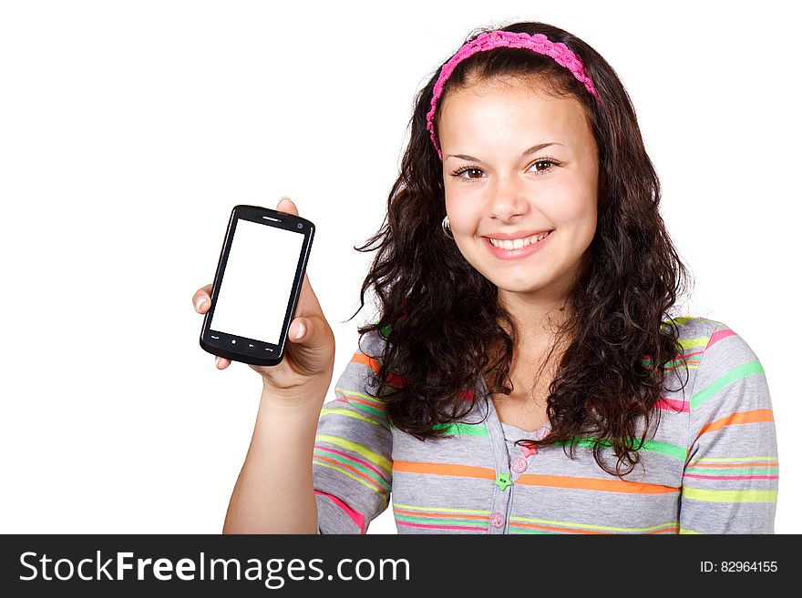 A girl holding up a smartphone. A girl holding up a smartphone.