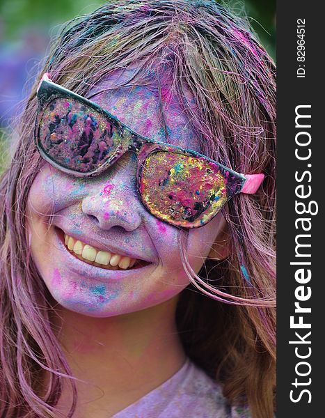 Girl in Black Framed Sunglasses With Color on Her Face from Color Run Smiling