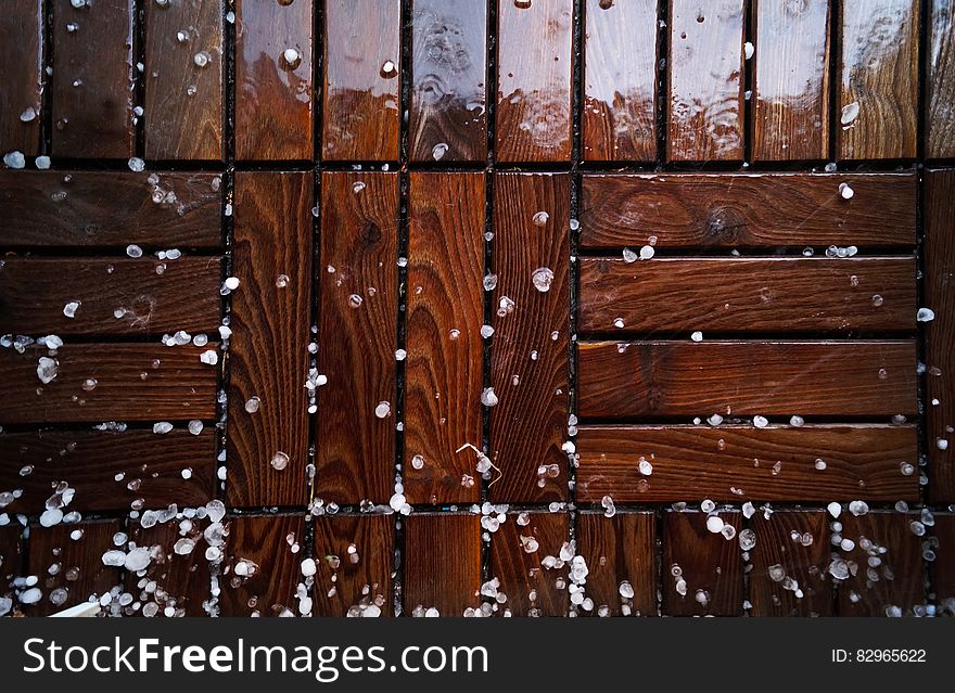 Shiny background created by wet woodblock flooring with hailstones or small ice pellets. Shiny background created by wet woodblock flooring with hailstones or small ice pellets.