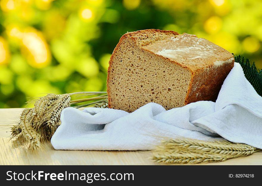 Brown Loft Bread in White Textile on Beige Table