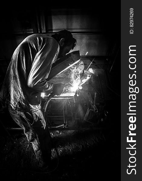 Greyscale Photo Of Person Having Welding