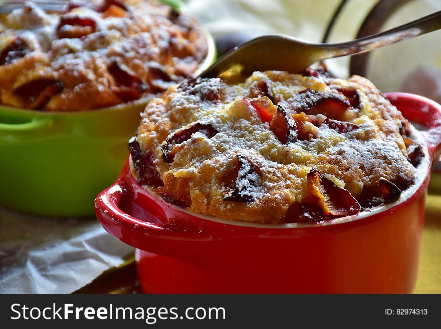 Stainless Steel Fork on Top of Brown Cooked Pastry on Top of Red Ceramic Mug