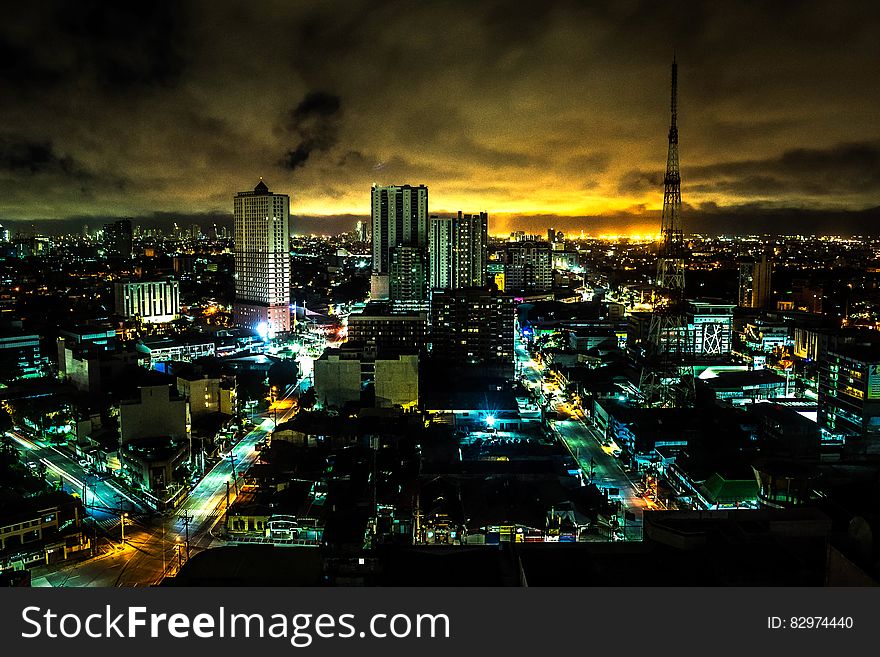 Landscape Painting of High Rise Building Under Brown Sky