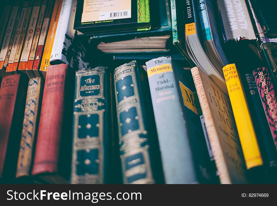 Stack of Brown and Red Printed Hardbound Books