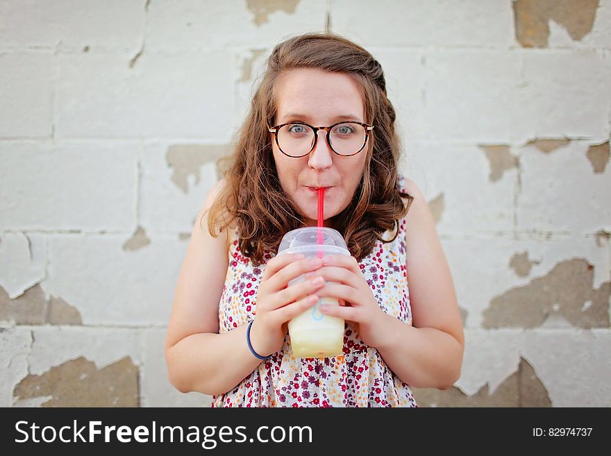 Woman in Black Framed Eyeglasses Drinking