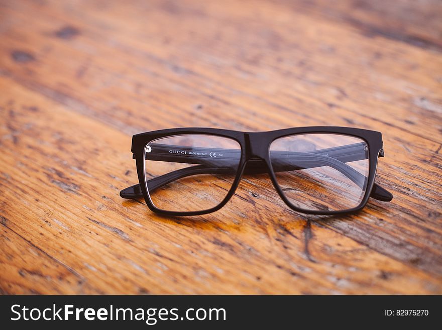 Black Frame Wayfarer Eyeglasses on Brown Wooden Surface