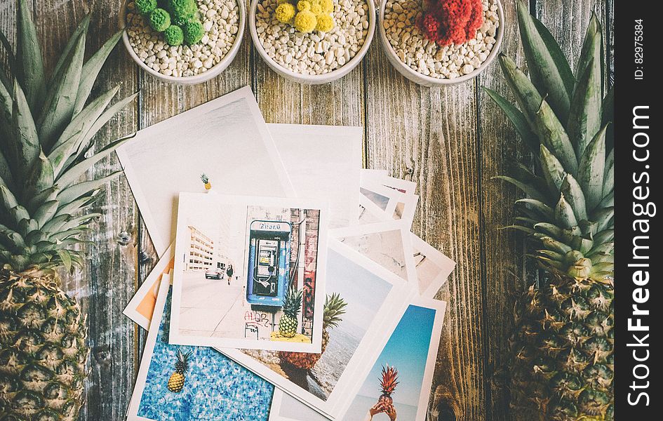 White Photo Paper Near 2 Pineapple Fruit