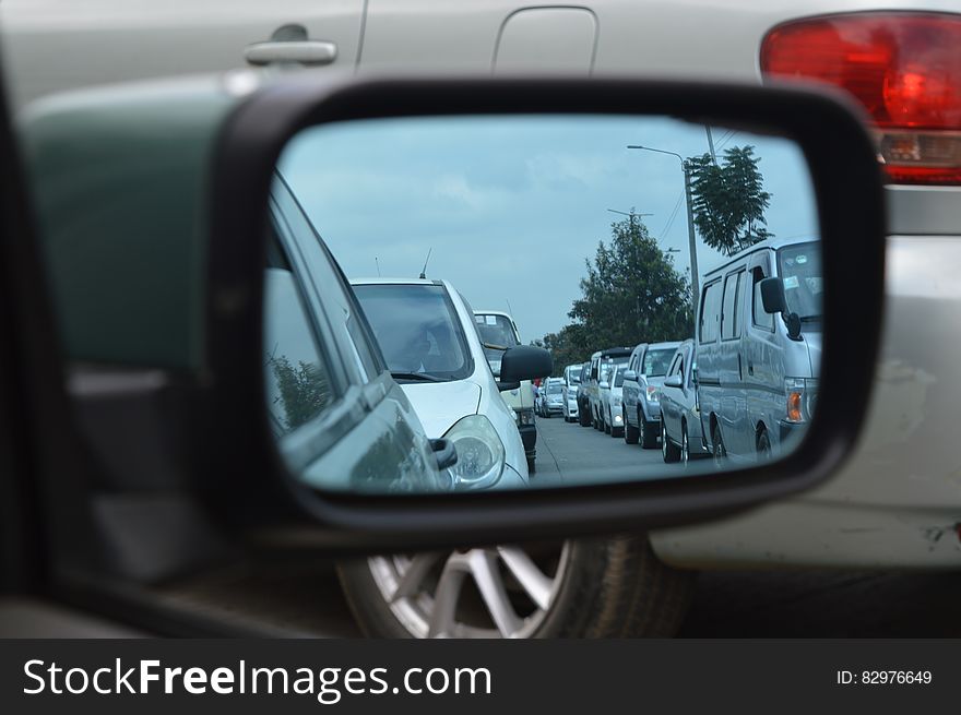 Car Side Mirror Showing Heavy Traffic