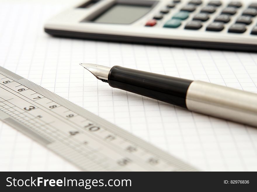 Shallow Focus Of Silver And Black Fountain Pen Beside Ruler And Scientific Calculator