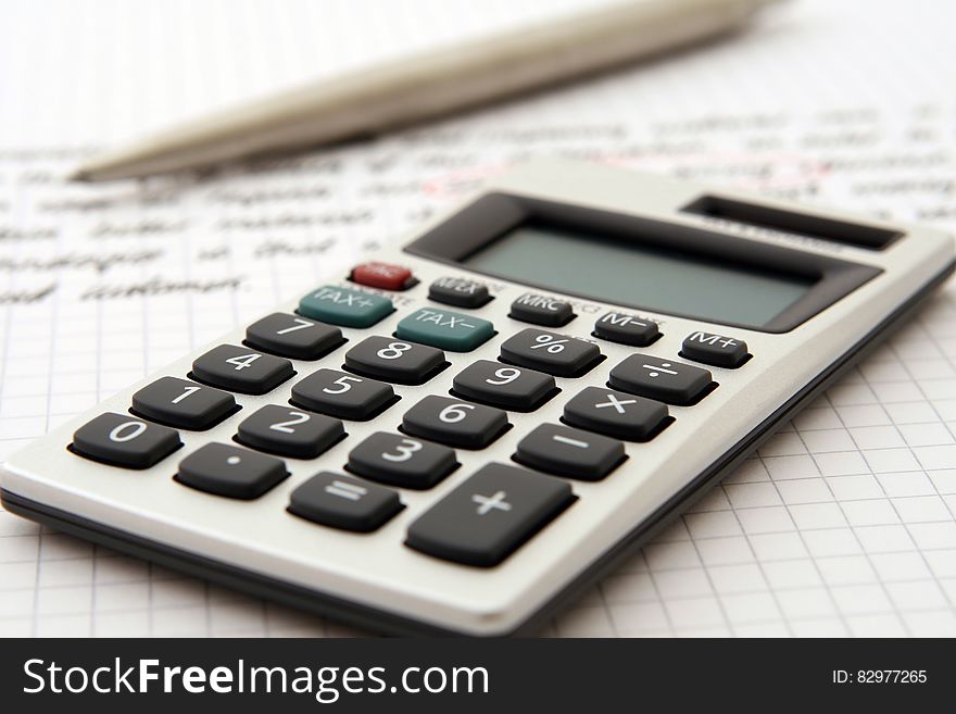 White and Black Desk Calculator on White Graphing Paper