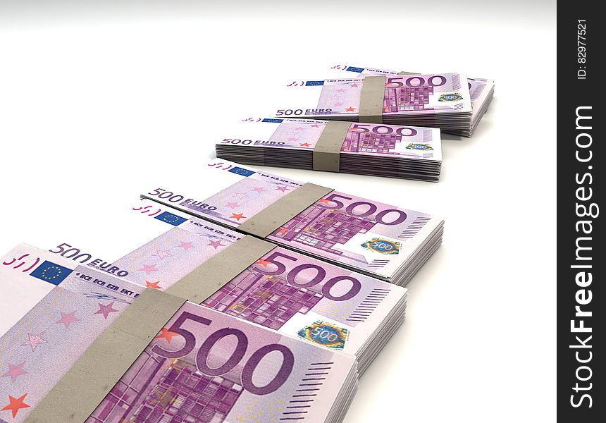 500 Euro notes in bundles on white.