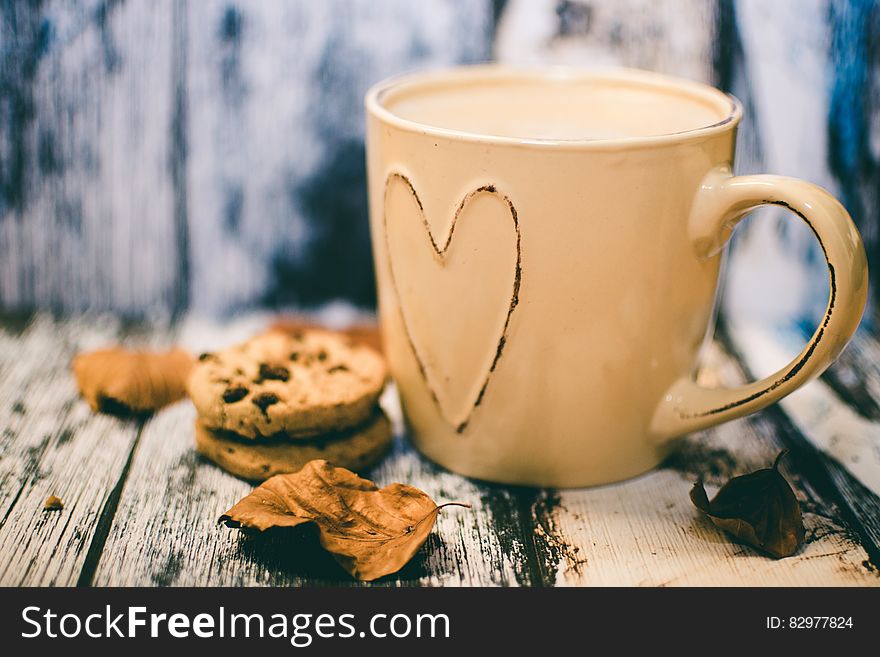 Beige Ceramic Heart Mug With Coffee Beside Cookie Food