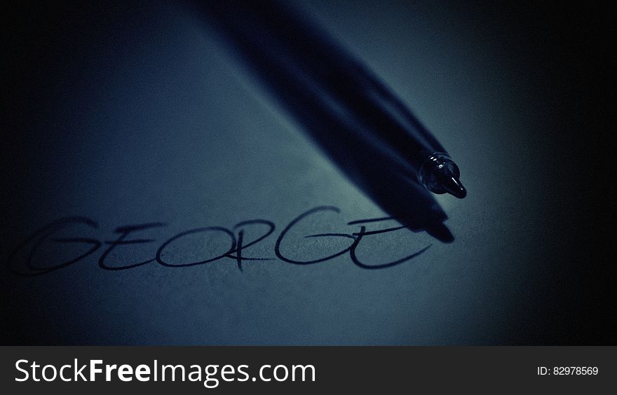 The name "George" written on the surface or a tablet with a pen or a stylus next to it. The name "George" written on the surface or a tablet with a pen or a stylus next to it.