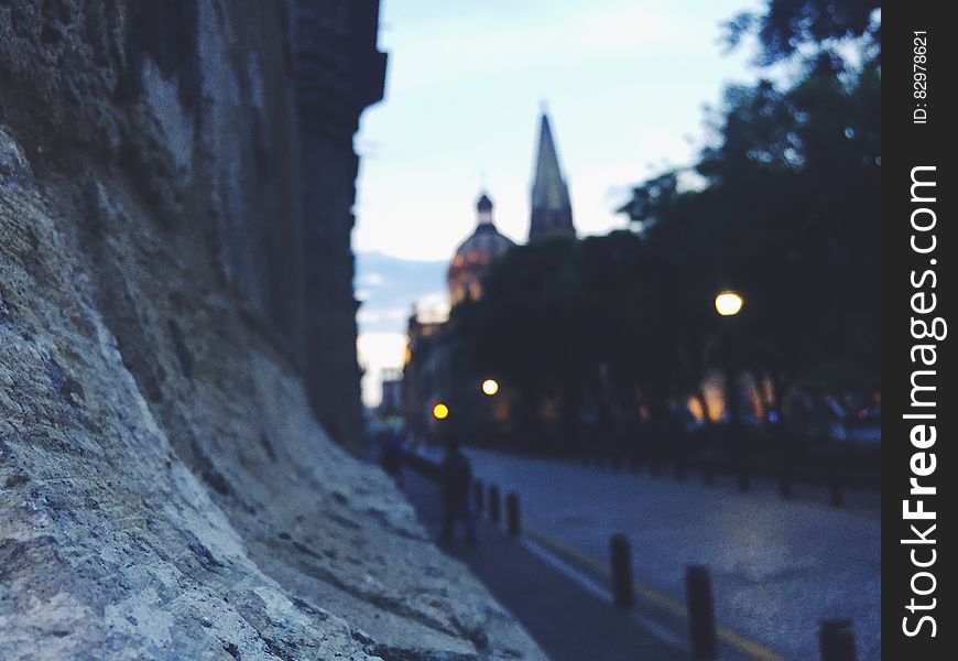 Close up of stone wall in town at twilight.