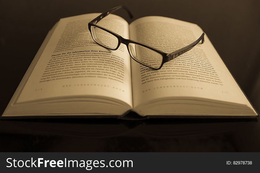 Black Frame Eyeglass in White Printed Book Page