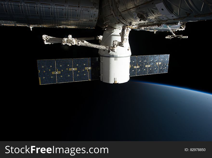 SpaceX COTS Dragon connected to the ISS by Canadarm2. SpaceX COTS Dragon connected to the ISS by Canadarm2.