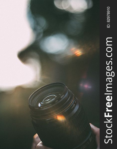 A camera lens with a bokeh background.
